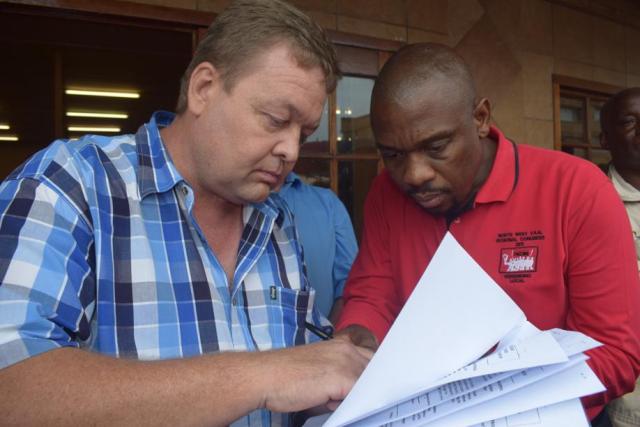 Gerhard Turkstra signs the memorandum of demands and promises to come up with a peaceful solution.

Photo: Selogile Leshage